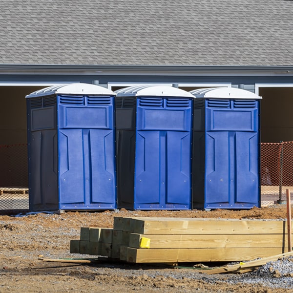 what is the cost difference between standard and deluxe porta potty rentals in Raymond